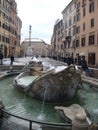 Fountain of the Barcaccia with few snow to Rome in Italy. 
