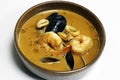 Famous french classic seafood bisque soup in a bowl with shrimp, lobster, crab, cuttlefish, squid, mussels and clams