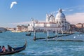 Grand Canal with gondola against Basilica Santa Maria della Salute in Venice, Italy