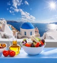 Greek salad against famous church in Oia village, Santorini island in Greece Royalty Free Stock Photo