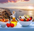 Greek salad against old town Thira on Santorini island in Greece Royalty Free Stock Photo