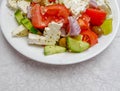 The famous Greek salad plate with Feta goat cheese, tomatoes, cucumbers, olives, onions and olive oil Royalty Free Stock Photo