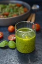 The famous green pesto sauce made from Basil, pine nuts, Parmesan and olive oil in a glass glass. Royalty Free Stock Photo