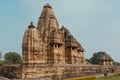 Famous Hindu temples in Khajuraho with reliefs and ancient sculptors on facades, India. Indian historical design