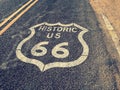 Famous historic us route 66 road asphalt sign covered with desert sand