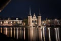 The famous historical `Waterpoort` in the city of Sneek at night with reflections in the canal - Sneek, Friesland, The Netherlan