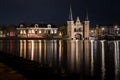 The famous historical `Waterpoort` in the city of Sneek at night with reflections in the canal - Sneek, Friesland, The Netherlan