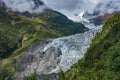 The majestic snow-capped mountains are covered by thick clouds