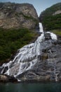 The famous and impressive waterfall The Suitor Friaren dropping down the rocks into the Geiranger Fjord Royalty Free Stock Photo