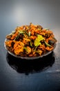 Famous Indian & Gujarati snack dish in a glass plate on wooden surface i.e. Patra or paatra consisting of mainly Colocasia Royalty Free Stock Photo