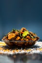 Famous Indian & Gujarati snack dish in a glass plate on wooden surface i.e. Patra or paatra consisting of mainly Colocasia Royalty Free Stock Photo