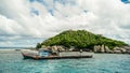 Scenic view tropical paradise with peaceful resort, rocky coastline, clear turquoise sea with coral reef against cloud sky. Koh Royalty Free Stock Photo