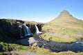 Famous kirkjufell mountain with the kirkjufell falls waterfalls in front in Iceland