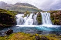 Famous Kirkjufellsfoss waterfall, favorite tourist destination in Iceland. Amazing dramatic landscape