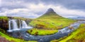 Famous Kirkjufellsfoss waterfall with Kirkjufell church mountain on the background, beautiful landscape, Iceland