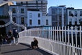 Girl sitting on Half Penny Bridge Dubliin