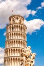 The famous leaning Tower of Pisa or La Torre di Pisa together with La Fontana dei putti, The Fountain with Angels at the Cathedral Royalty Free Stock Photo