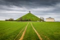 Famous Lion`s Mound memorial site at the battlefield of Waterloo with dark clouds, Belgium Royalty Free Stock Photo