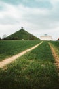 Famous Lion`s Mound memorial site at the battlefield of Waterloo with dark clouds, Belgium