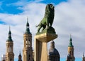 Famous lion sculputure in the Stone Bridge Puente de Piedra over the Ebro river nex to to Basilica of Our Lady of the Pillar Royalty Free Stock Photo