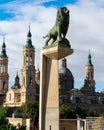 Famous lion sculputure in the Stone Bridge Puente de Piedra over the Ebro river nex to the Basilica of Our Lady of the Pillar Royalty Free Stock Photo