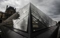 Famous Louvre under a dark cloudy sky in Paris France