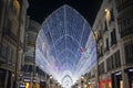 The famous main street of Malaga - the Marquis de Larios at night. Bright lighting, garlands and lights on a pedestrian street.