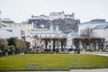 Famous Mirabell gardens, view to old historic Hohensalzburg fortress, geometrically-arranged park, castle on the hill, green grass