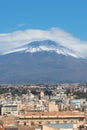 Famous Mount Etna volcano in Sicily, Italy captured on vertical picture with houses belonging to city Catania located at the foot Royalty Free Stock Photo