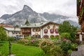 Classic Bavarian Village with Chalet Style Homes and Misty Mountains and lots of flowers