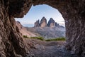 Famous mountains Three Peaks in the Dolomites from a cave during sunset Royalty Free Stock Photo