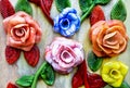 Famous murano glass. Coloured glass flowers on wooden background. Shop in Murano, Venice, Italy.