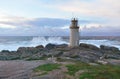 Famous Muxia Lighthouse with wild waves splashing and sunset light. Galicia, Spain. Royalty Free Stock Photo