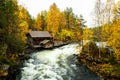 Myllykoski wooden watermill by the river rapids during colorful autumn foliage in Oulanka National Park, Northern Finland. Royalty Free Stock Photo