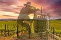 Famous Napa Valley Vineyards and Sunrise Sky and Grape Crusher Statue superimposed in the photo. Royalty Free Stock Photo