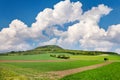 National mystic hill Rip, Central Bohemia, Czech republic - spring landscape with green fields and blue sky with clouds Royalty Free Stock Photo