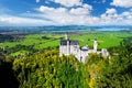 Famous Neuschwanstein Castle, fairy-tale palace on a rugged hill above the village of Hohenschwangau near Fussen Royalty Free Stock Photo