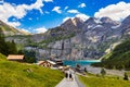 Famous Oeschinensee with Bluemlisalp mountain on a sunny summer day. Panorama of the azure lake Oeschinensee. Swiss alps,