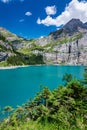 Famous Oeschinensee with Bluemlisalp mountain on a sunny summer day. Panorama of the azure lake Oeschinensee. Swiss alps, Royalty Free Stock Photo