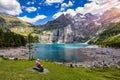 Famous Oeschinensee with Bluemlisalp mountain on a sunny summer day. Panorama of the azure lake Oeschinensee. Swiss alps, Royalty Free Stock Photo