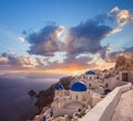 Oia village with churches against Aegean sea on Santorini island in Greece Royalty Free Stock Photo