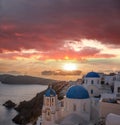 Oia village with churches against sunset on Santorini island in Greece Royalty Free Stock Photo