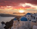 Oia village with churches against sunset on Santorini island in Greece Royalty Free Stock Photo