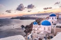 Oia village with churches against sunset on Santorini island in Greece Royalty Free Stock Photo