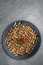 Okonomiyaki traditional japanese savoury pancake dish in restaurant on grey background Royalty Free Stock Photo
