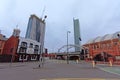 Old pub and industrial building in front of modern skyscrapers in Manchester