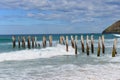 Old poles on St Clair beach in Dunedin Royalty Free Stock Photo