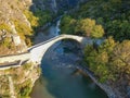 The famous old stoned bridge of Konitsa over Aoos river. Tymfi mount, Zagori, Epirus, Greece, Europe Royalty Free Stock Photo