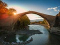 The famous old stoned bridge of Konitsa over Aoos river. Tymfi mount, Zagori, Epirus, Greece, Europe Royalty Free Stock Photo