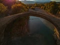 The famous old stoned bridge of Konitsa over Aoos river. Tymfi mount, Zagori, Epirus, Greece, Europe Royalty Free Stock Photo